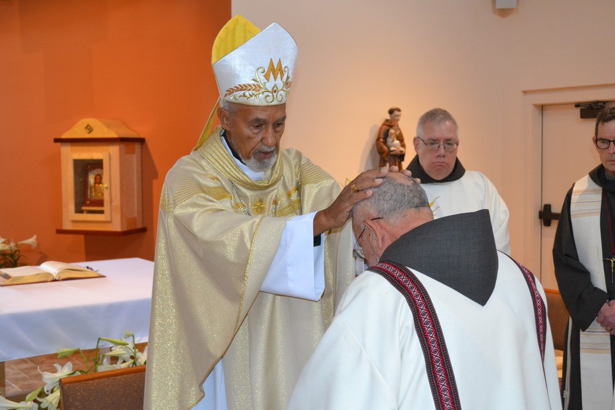 Most Reverend Donald J. Reece Lay Hands in Ordination on Fr. Jose Delgado, SA